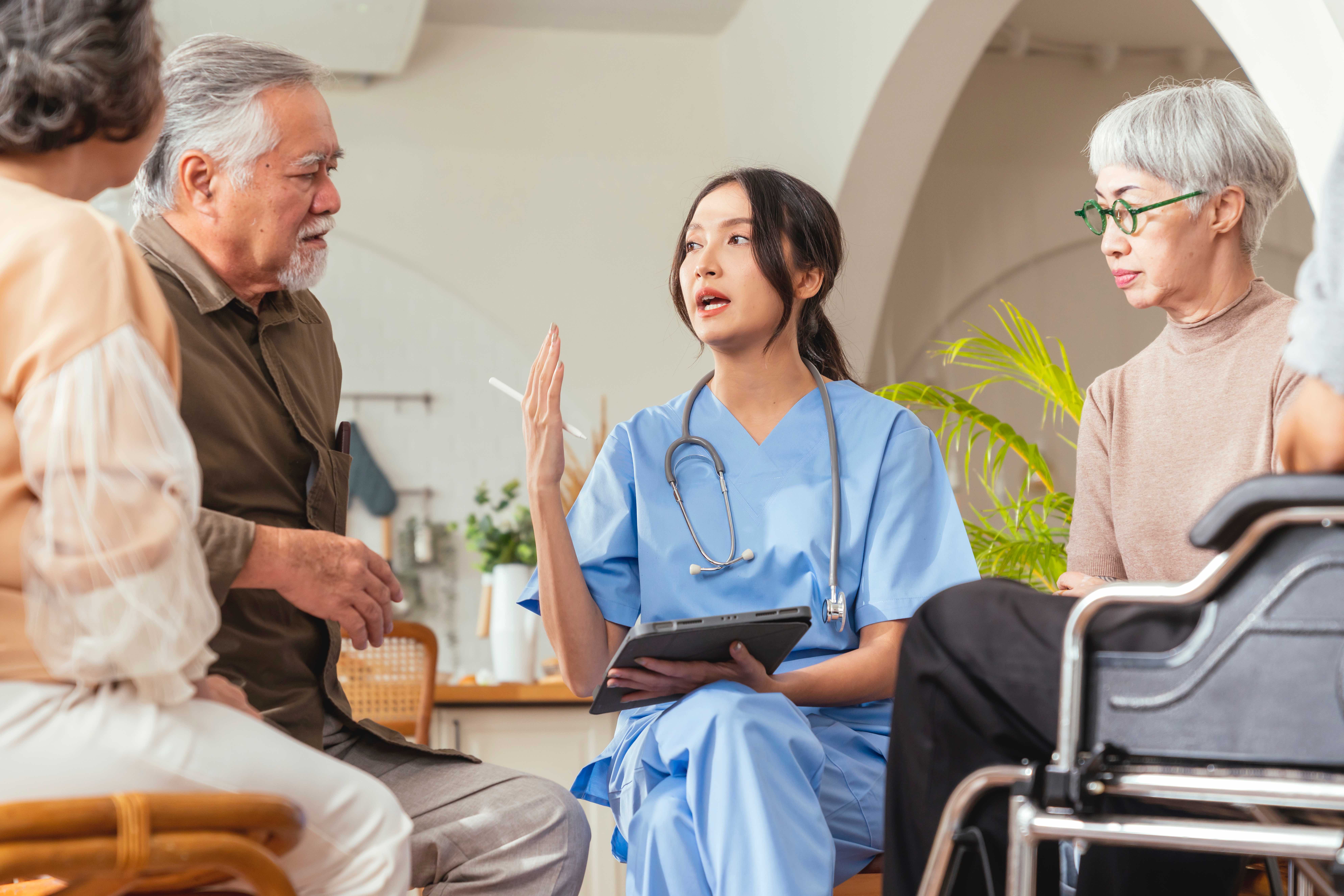 Healthcare provider consulting with elderly patients